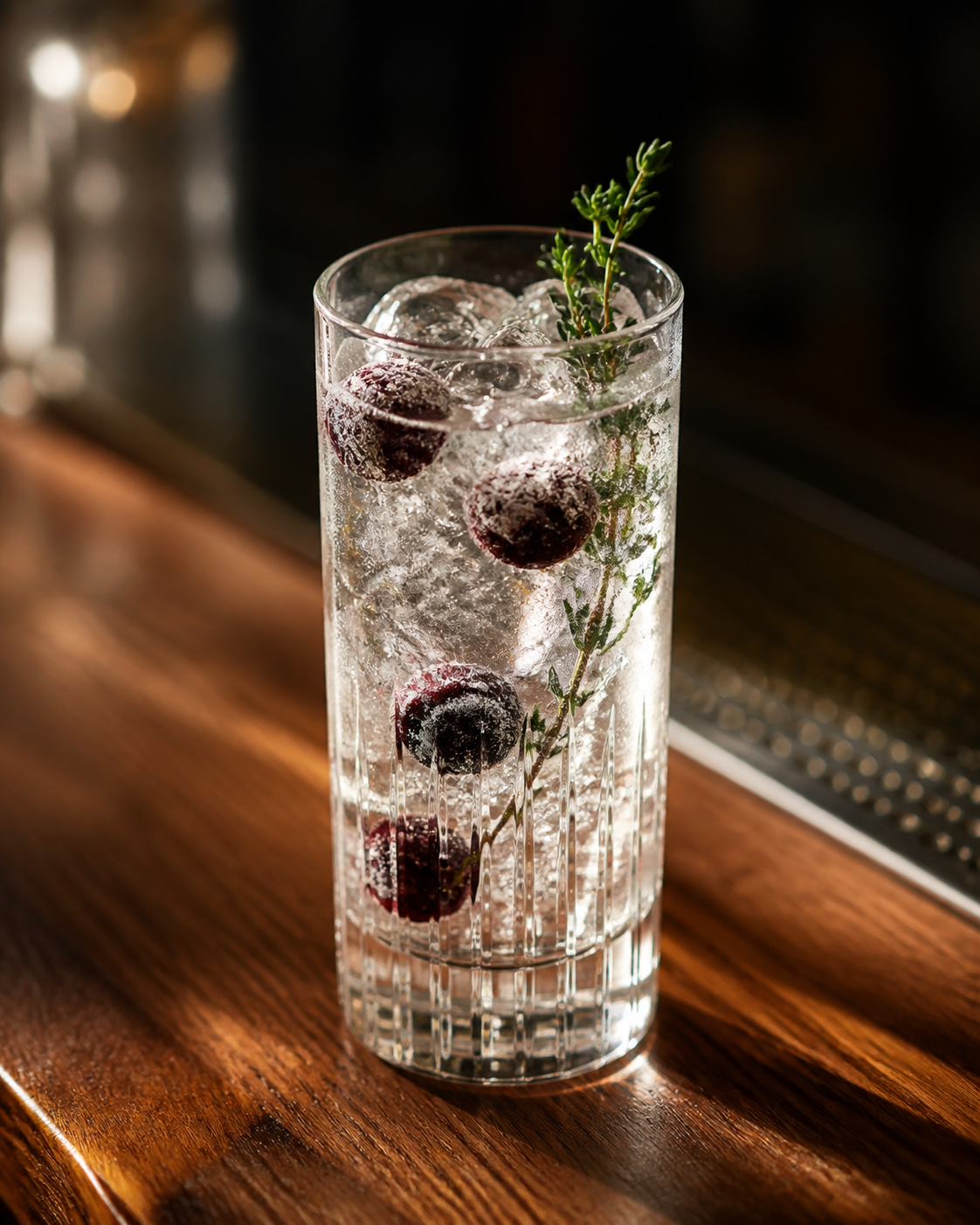 Wolf Premium Gin served with Fever-Tree Mediterranean Tonic Water, garnished with frozen cherries and thyme sprig